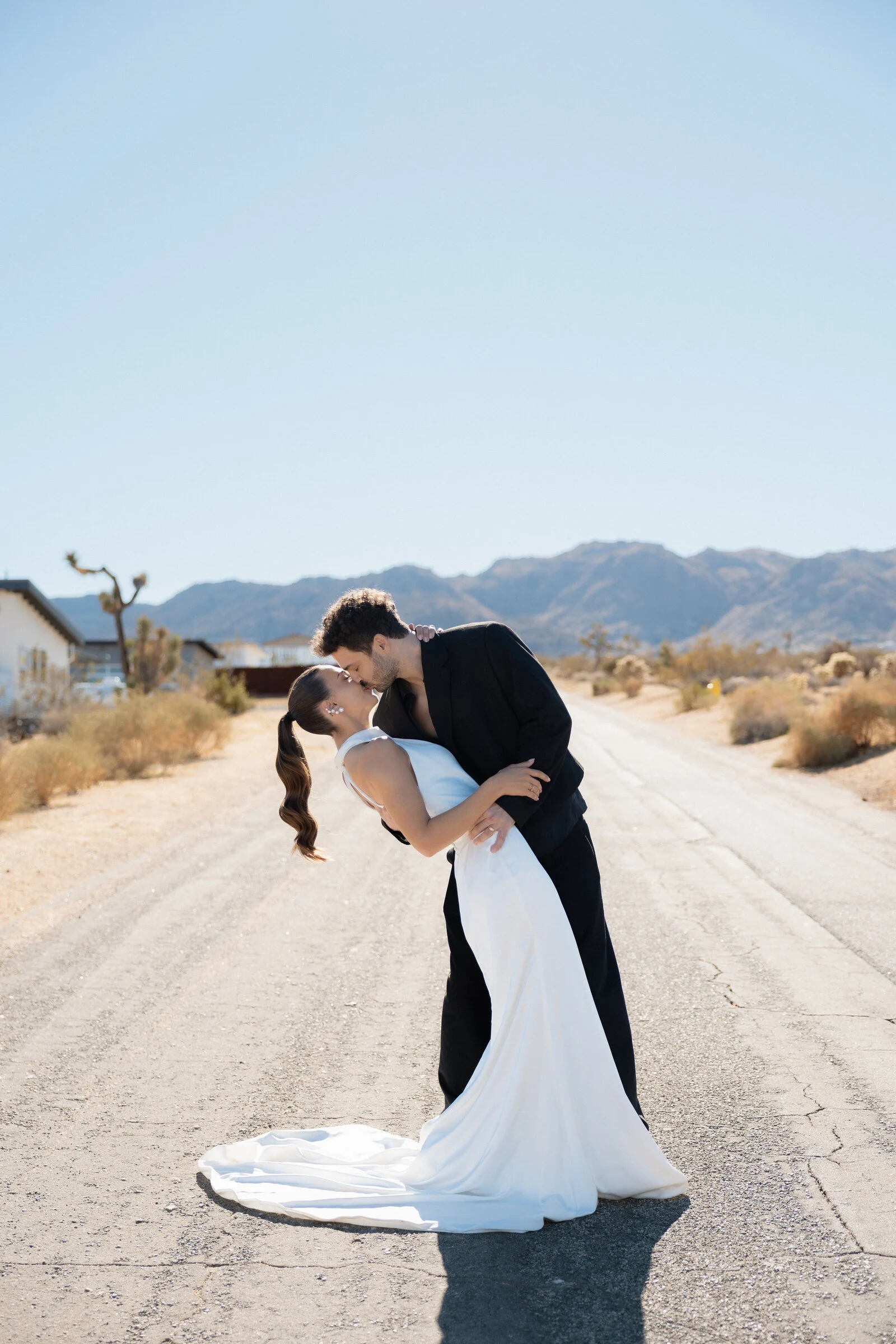 A couple embracing on a quiet desert road