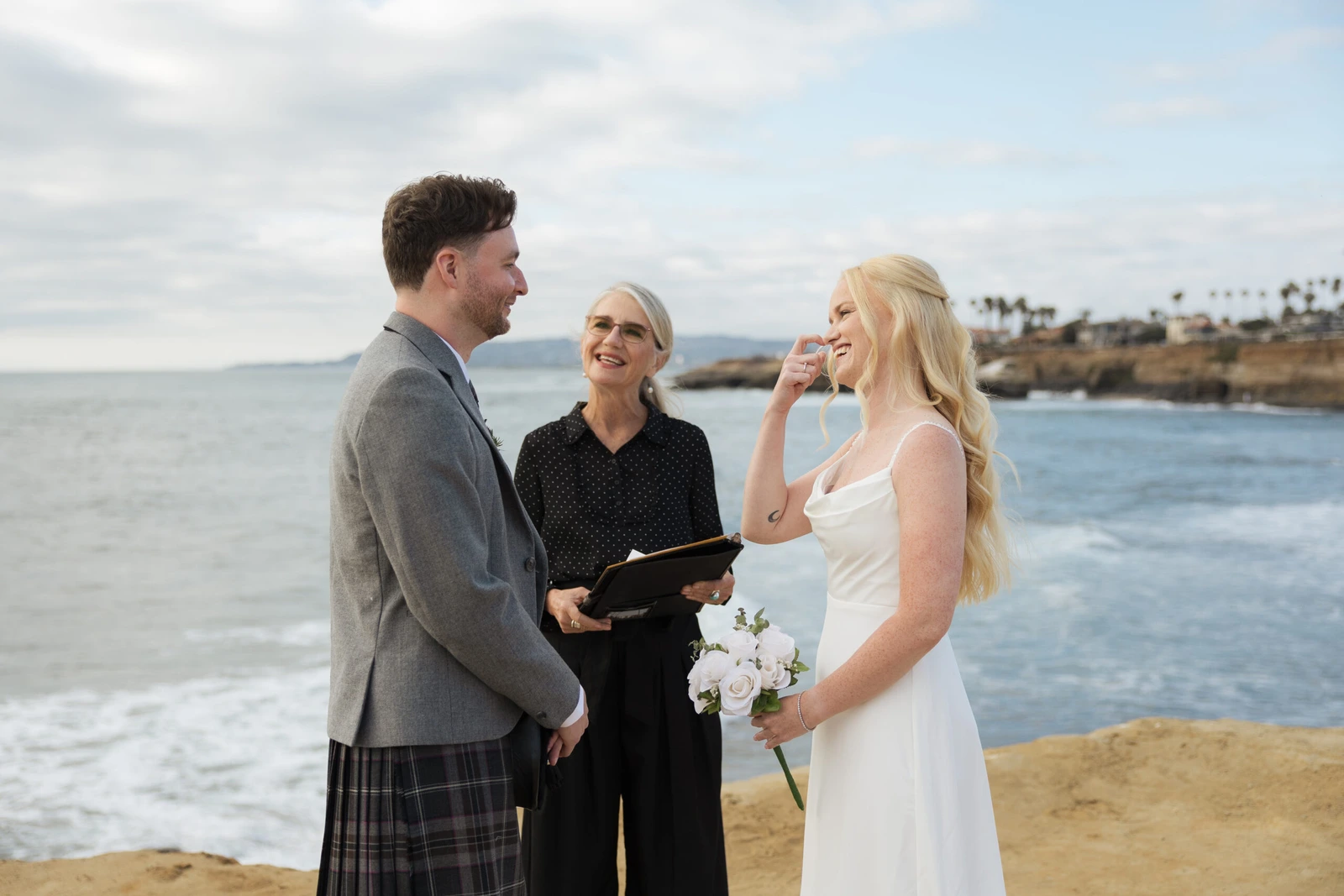A couple celebrating their wedding above the ocean at Sunset Cliffs in San Diego