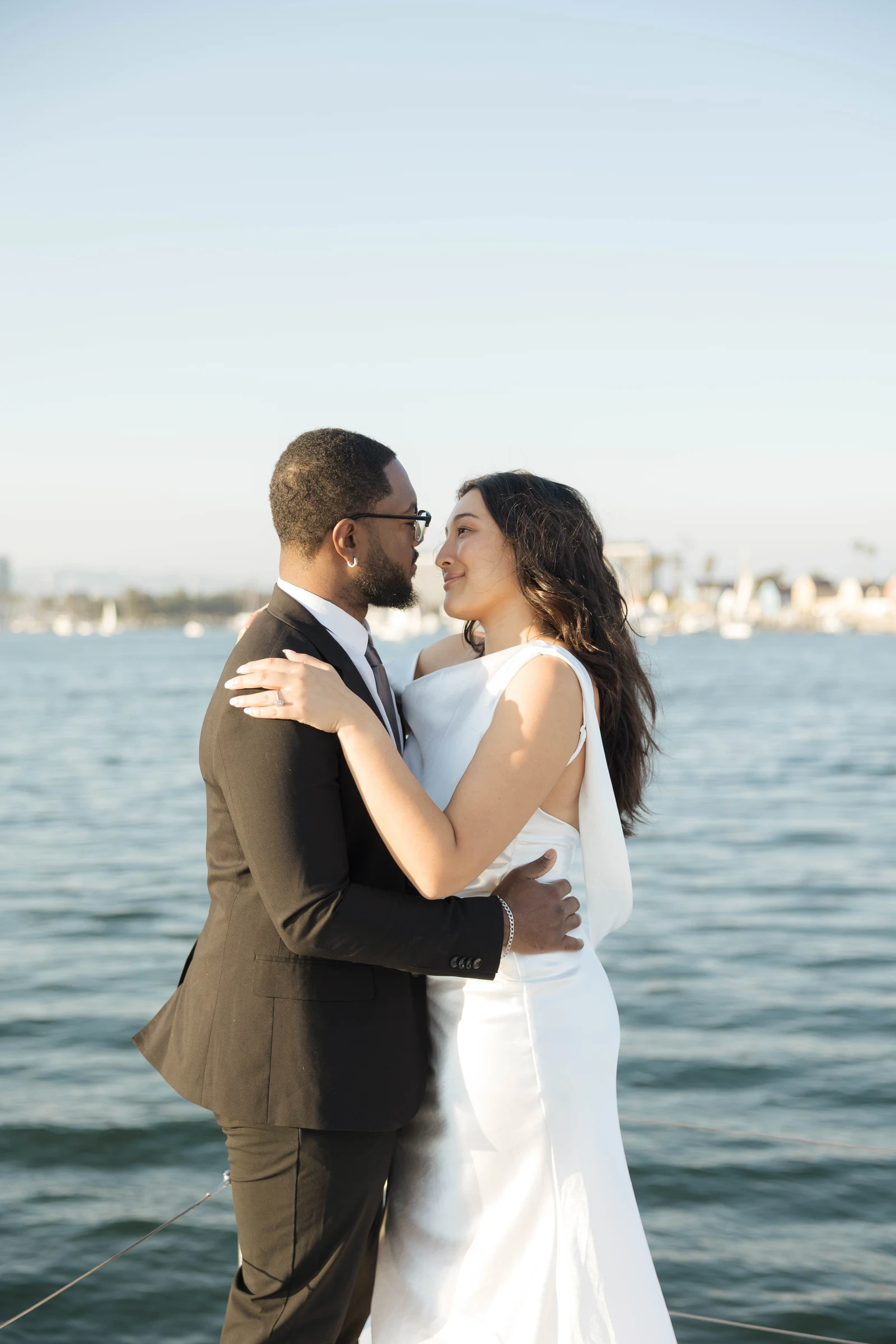 Couple embracing on a boat after eloping in Malibu
